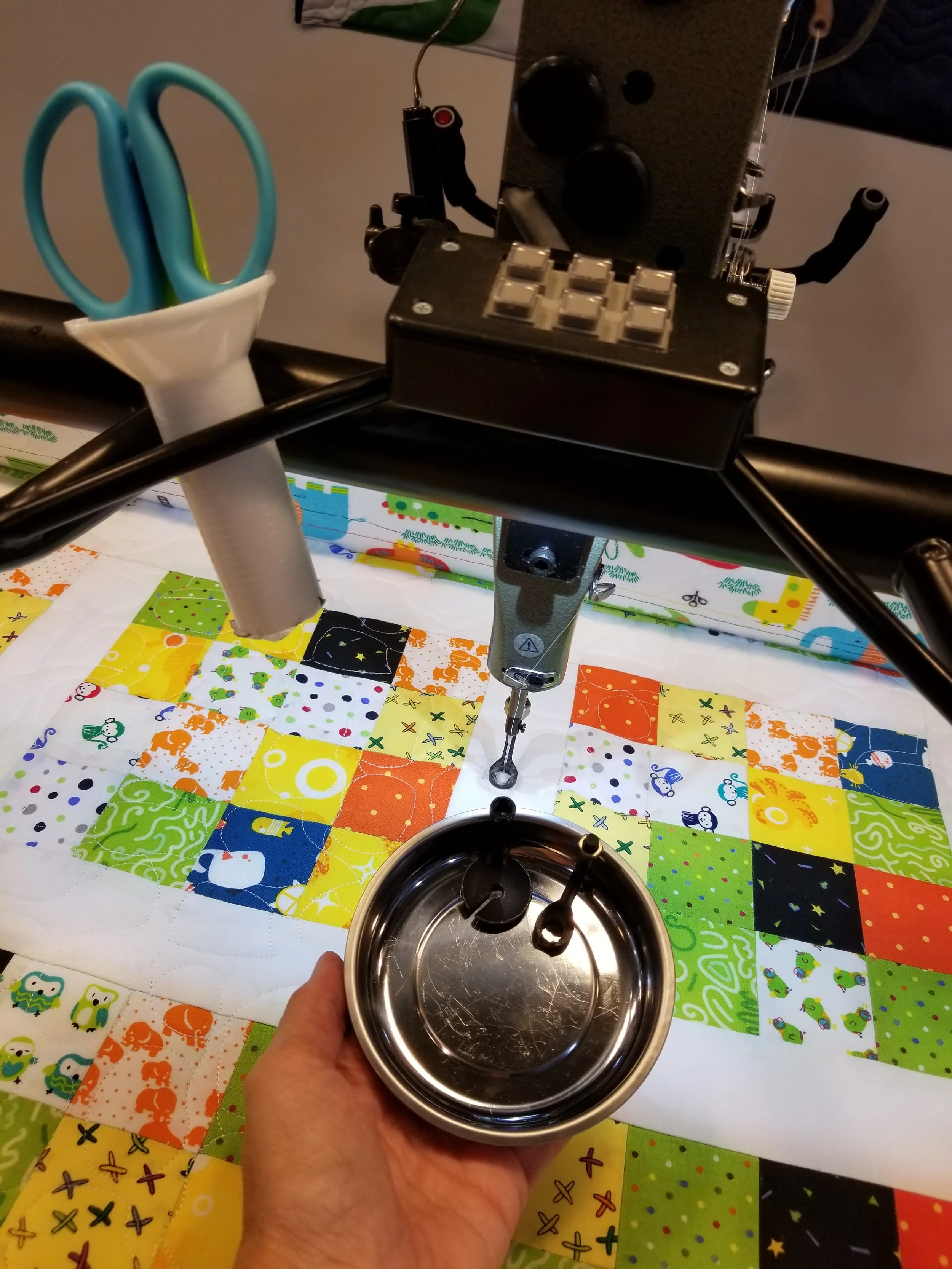 Here are three of the feet we often use when quilting on the Statler as well as an inverted spool to hold scissors and seam ripper.