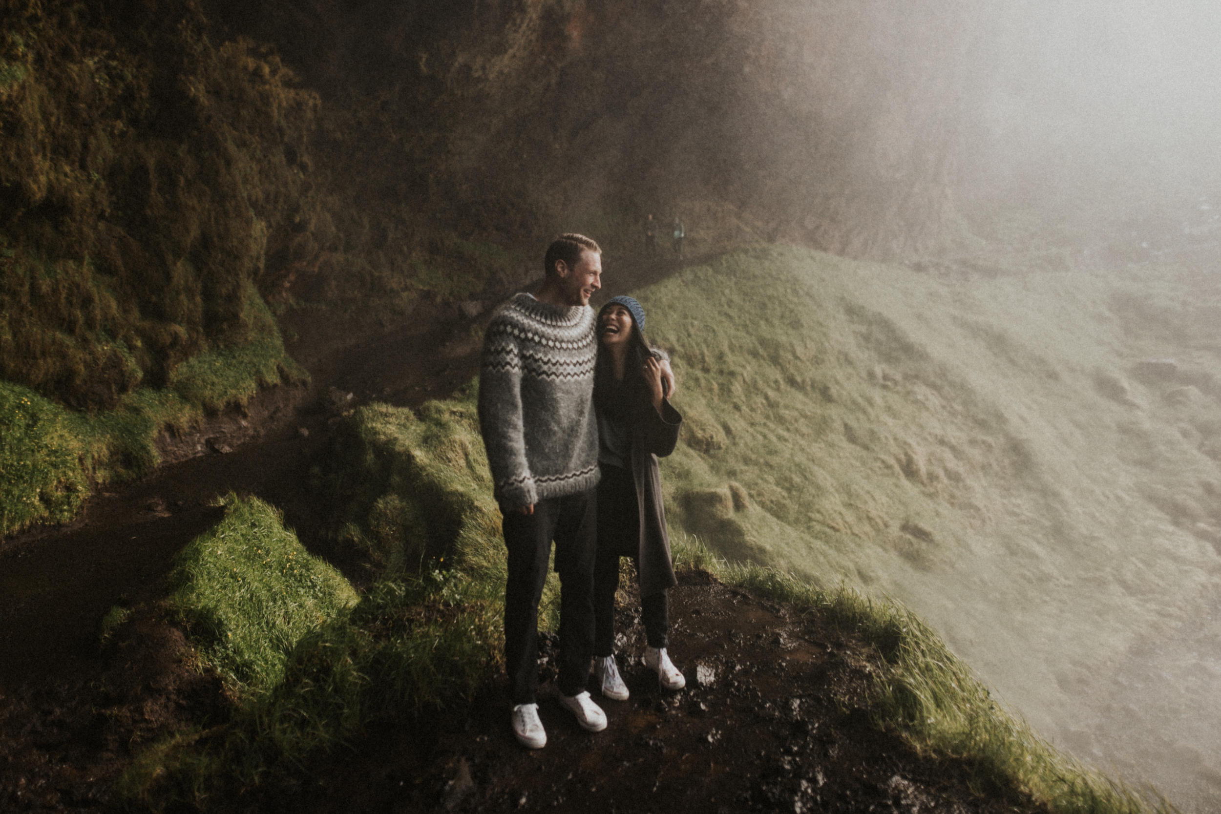 Happy couples session behind Icelandic waterfall.jpg