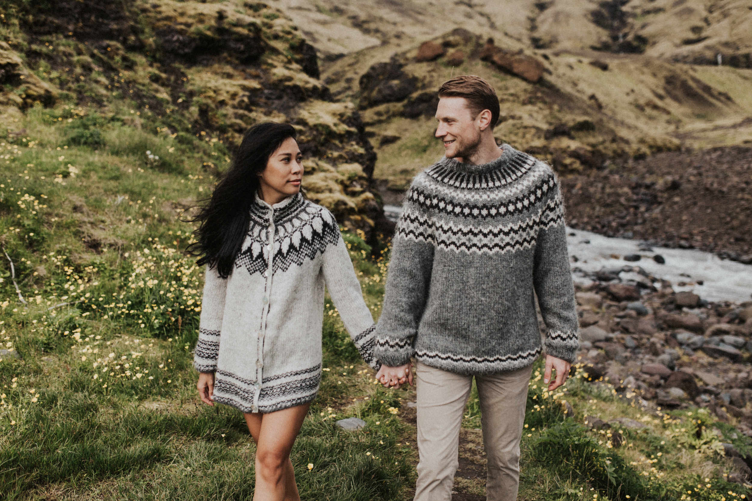 Barefoot couple walking in wilderness of Iceland in sweaters.jpg
