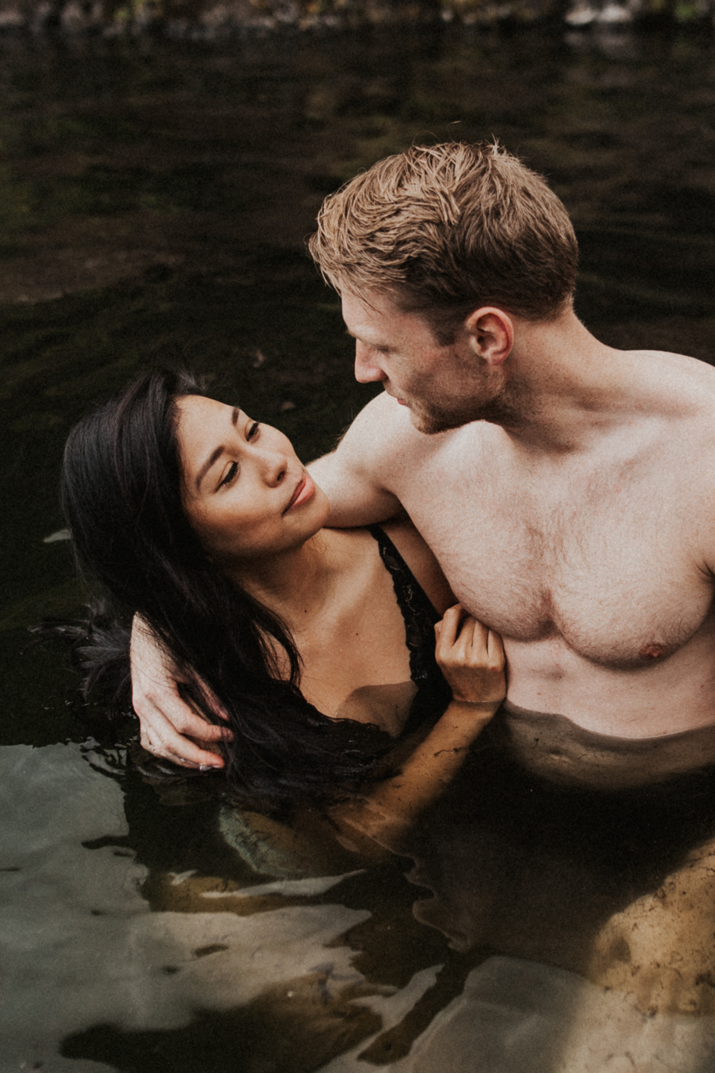 Beautiful mixed race couple in Seljavallalaug hot springs in Iceland.jpg