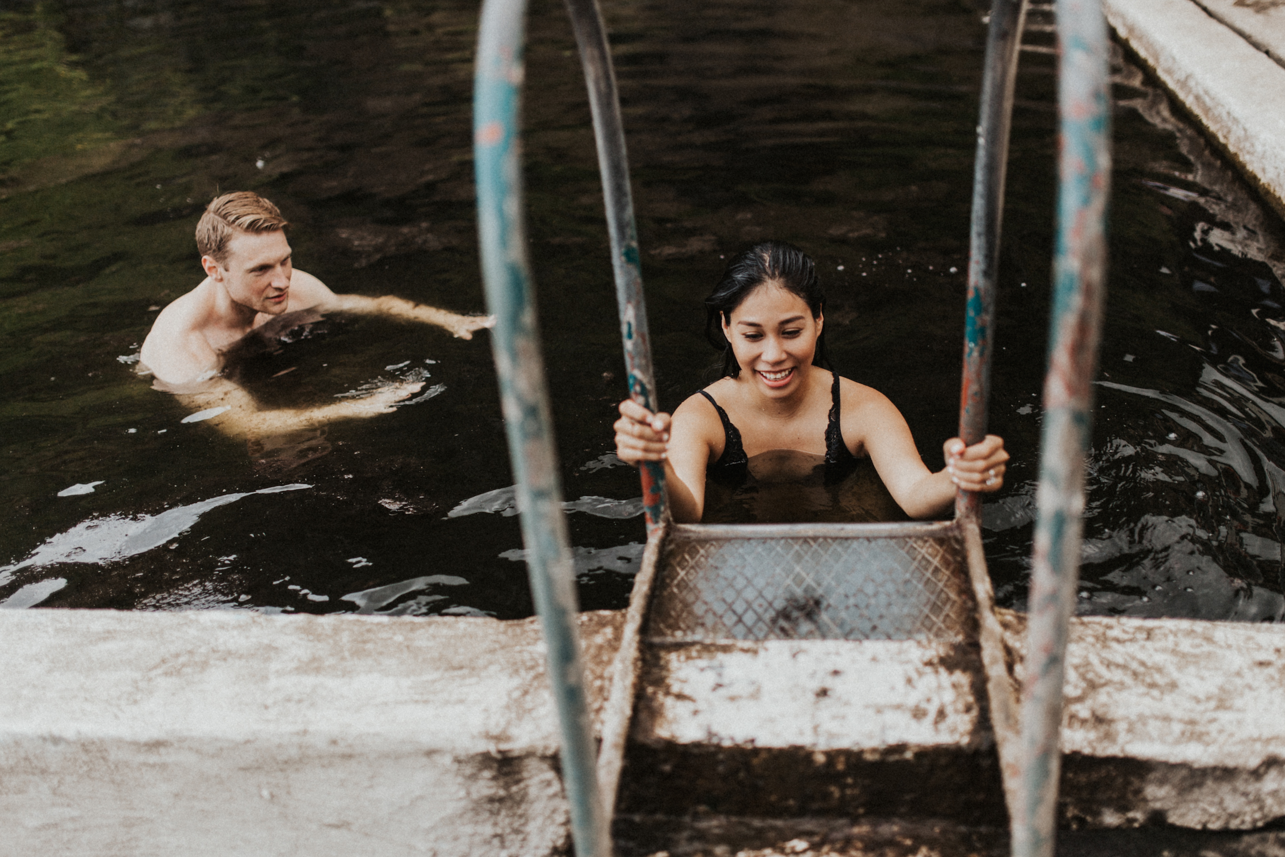 Couple climbing out of Seljavallalaug hot springs in Iceland.jpg