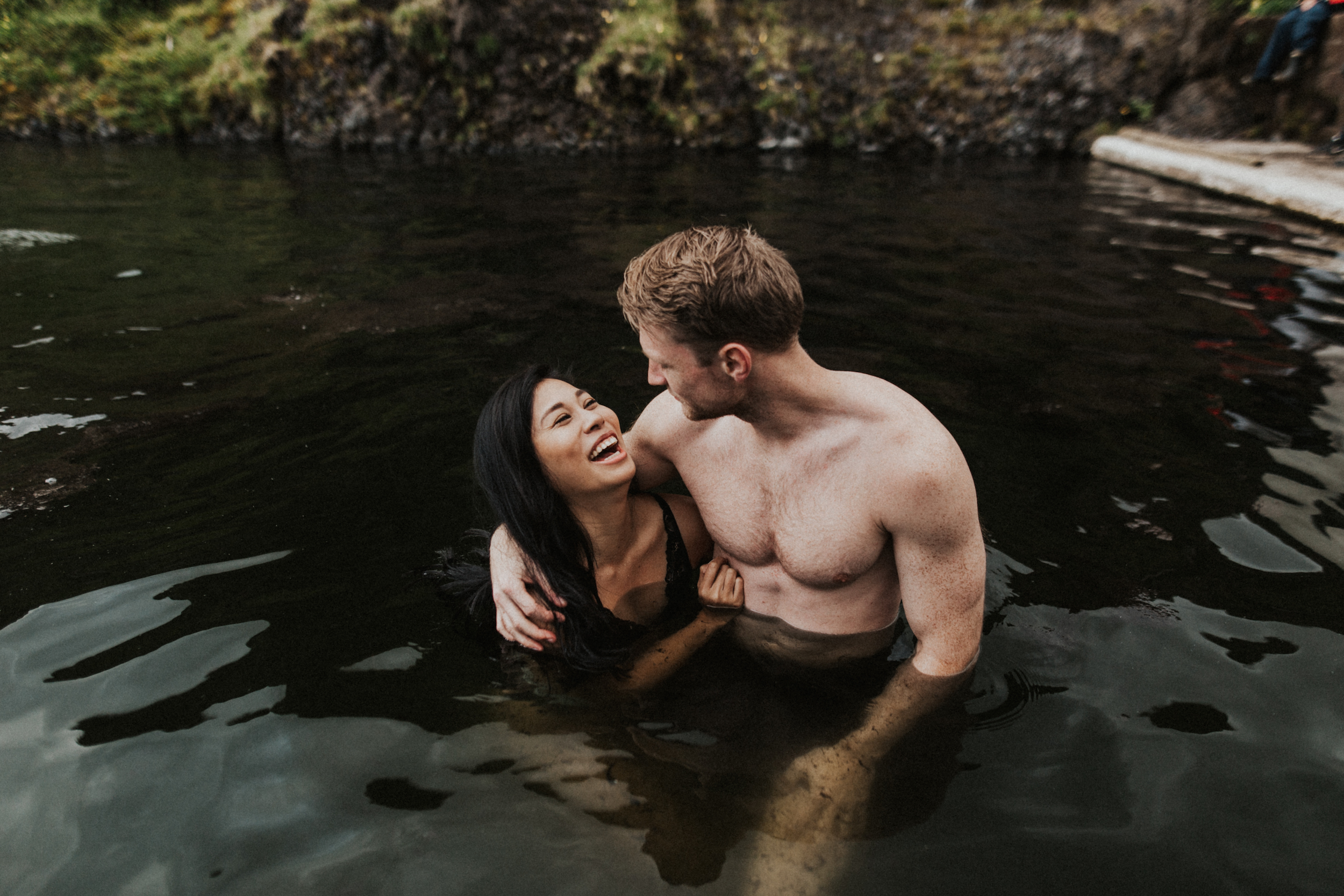 Laughing couple during photo session in Seljavallalaug hot springs in Iceland.jpg