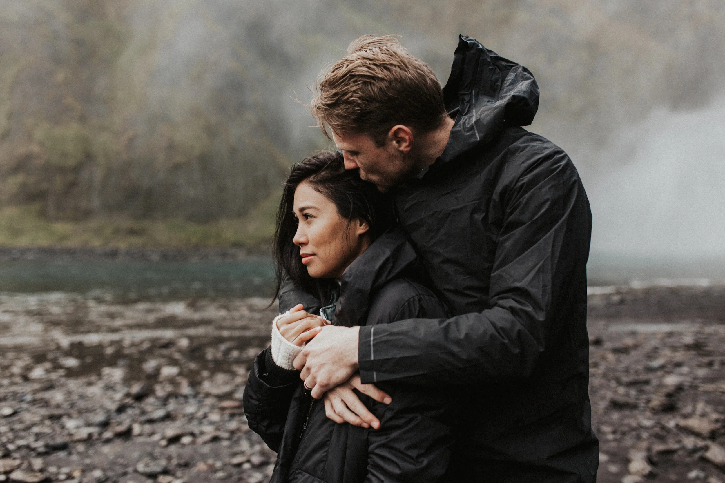 Side shot of couple at Skógafoss waterfall in Iceland.jpg