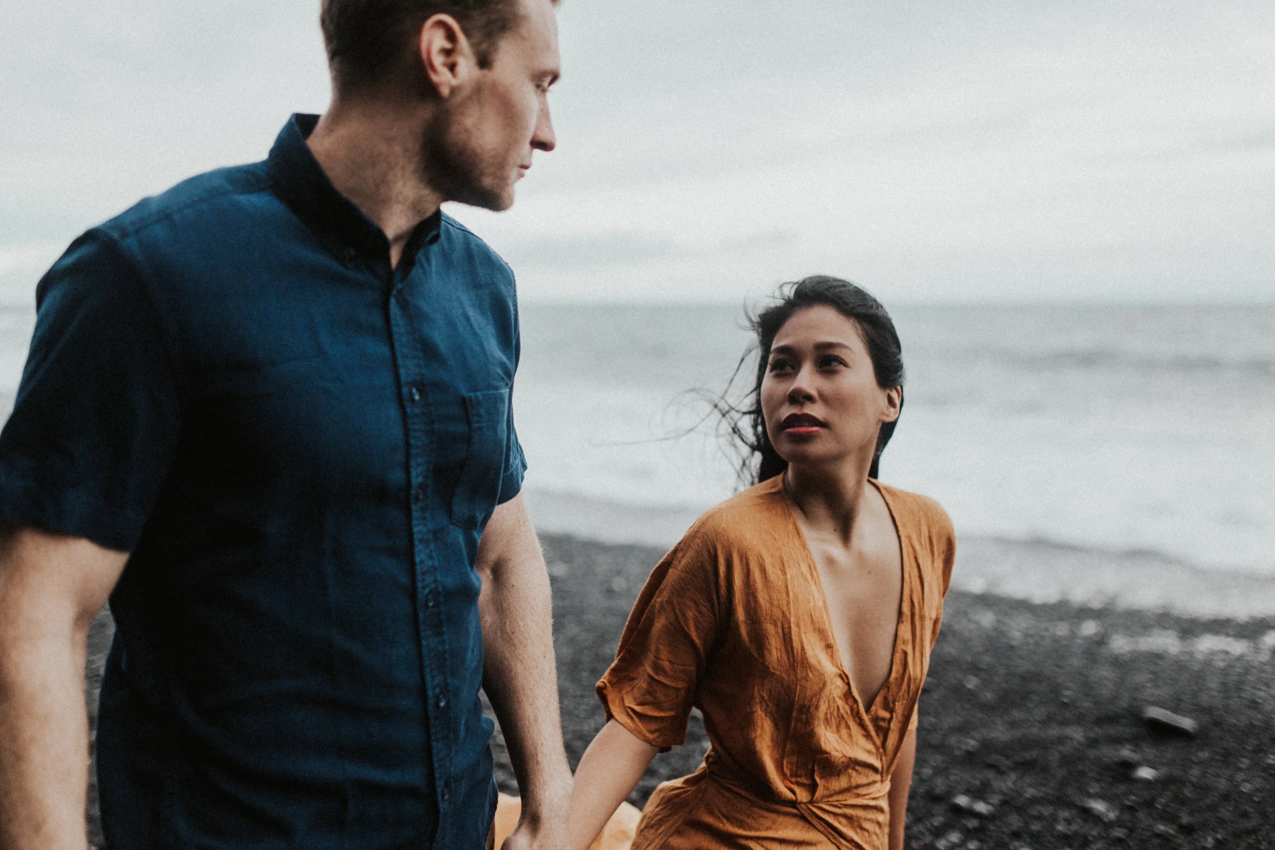 couple gazing at eachother in iceland on vik beack.jpg