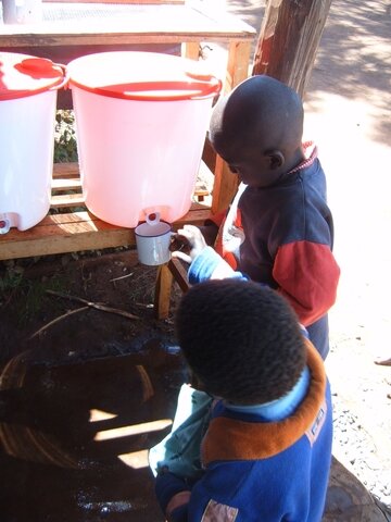 medium_Pupils_at_Chelelek_Pri_getting_water_from_safe_water_storage_container.jpeg