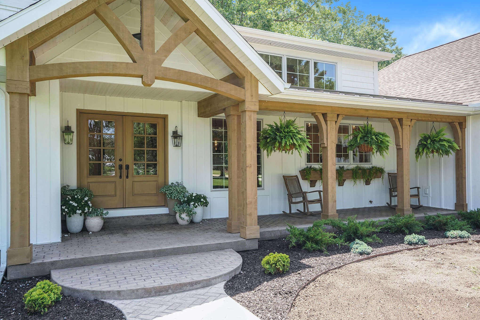 front porch. farmhouse porch. stained columns. white exterior.jpg