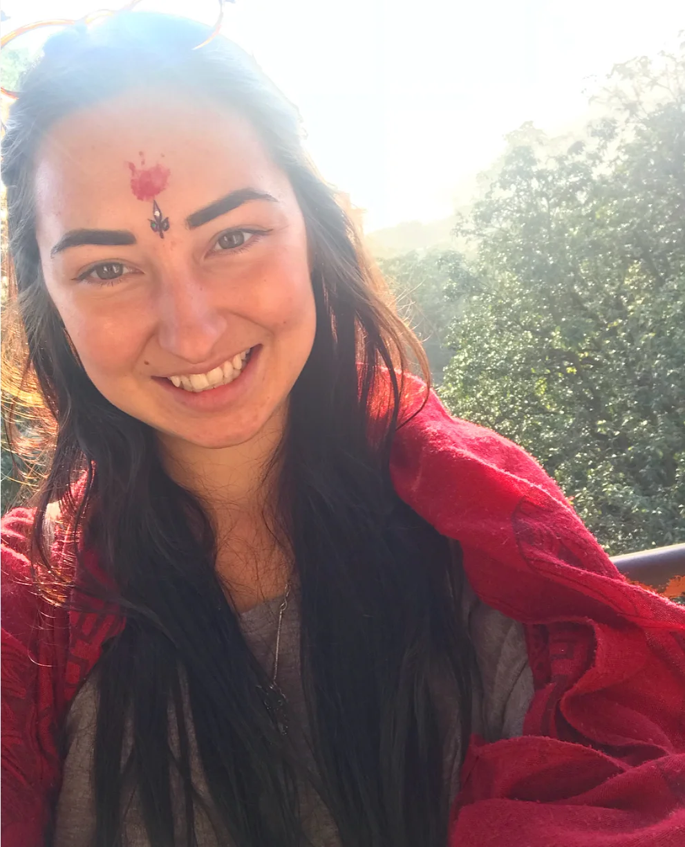 Blessed at the temple, represented by the red mark on the forehead (the third eye chakra) .