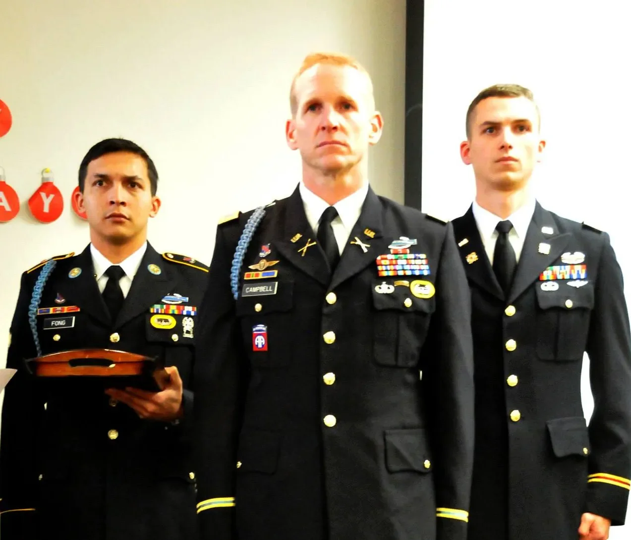 Sergeant major standing with two other army men in uniform