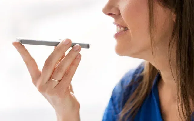 Woman speaking her intentions into a cell phone
