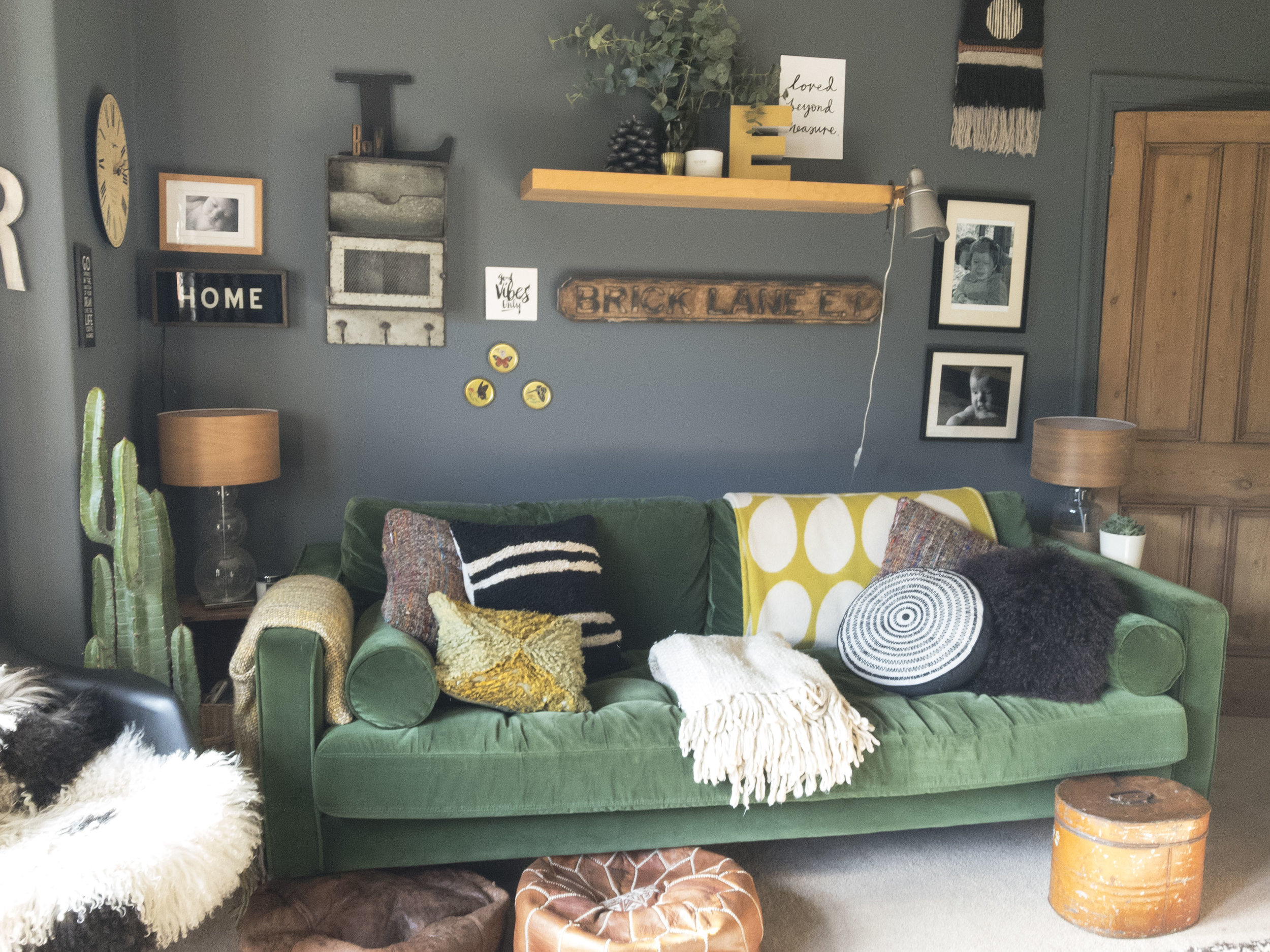 Picture 2 shows my green velvet sofa from MADE , against a painted wall in downpipe by Farrow and Ball . Sources: Cushions, Grey September Stores , Covet Ilkley . Black circle cushion, Yellow thrown; Orla Keirly . Faux plants and eucalyptus . Moroccan poufs, picked up at the souk in Morocco. Industrial light. Covet, as above. Wall hanging. Happy Mountain Designs. Etsy. All other items sources as thrift/ebay