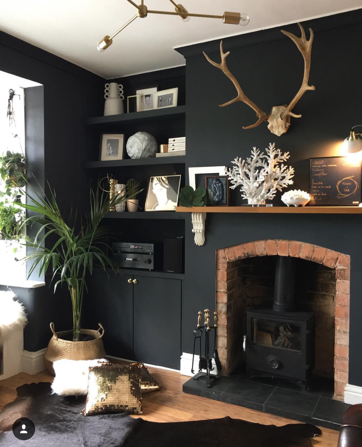 A particular favourite of mine is Nadia's front room, when I visited in November, this fire was on and this whole room was cosy an inviting. I particularly like the dark walls (naturally given my own taste) but love the use of the lighter and warm colours against it. You will see the use of gold is a theme throughout the house. "The antlers are from a local deer park," Nadia shares. "They were so big I could barely carry them."