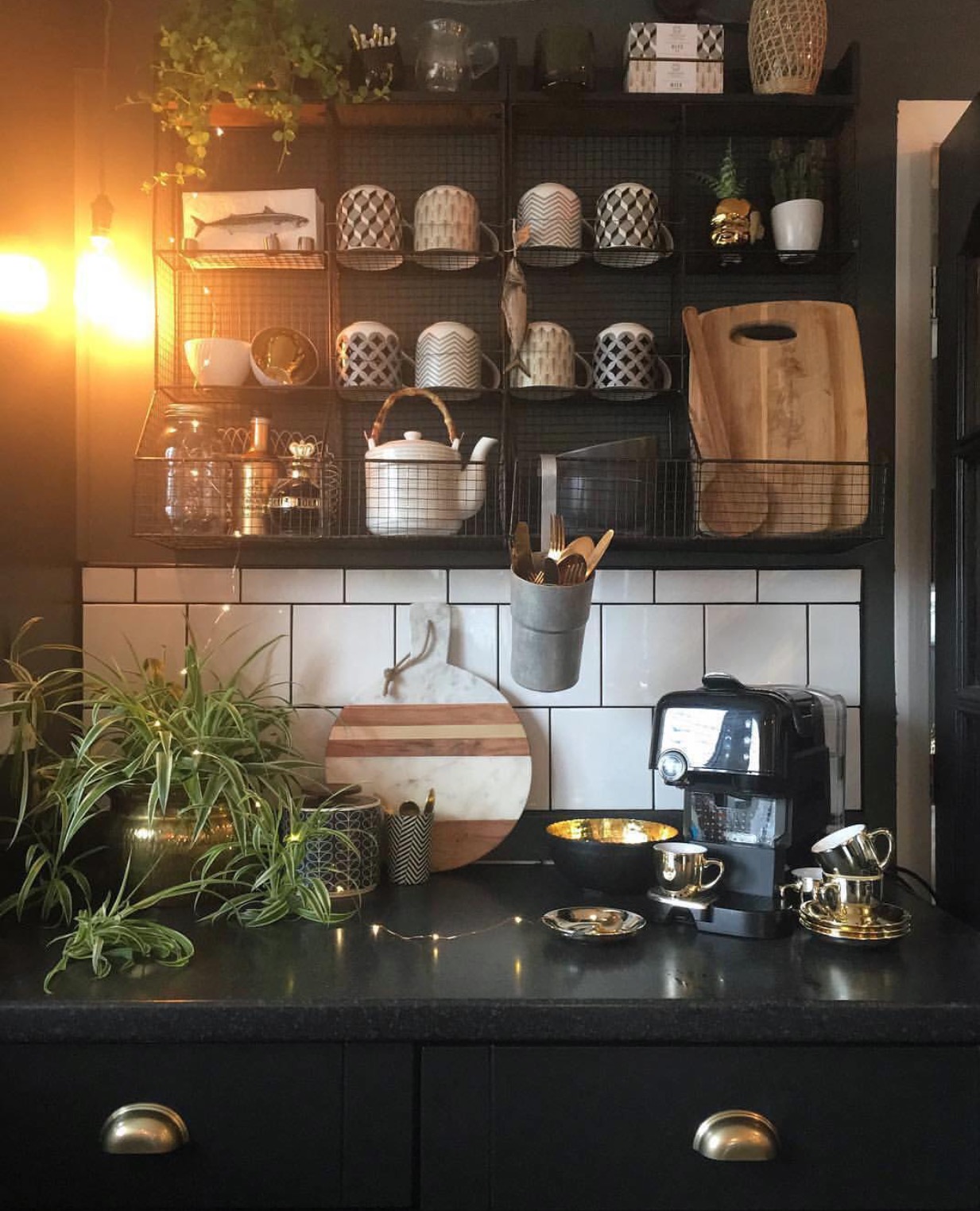 Nadia replaced old black tiles with white ones and spent many weekends painting the cabinets. "Not a job I enjoyed," Nadia admits. "It took a lot longer than anticipated, yet I am pleased with the result." Nadia loves to display her favorite kitchen bits and pieces in her wire shelves.