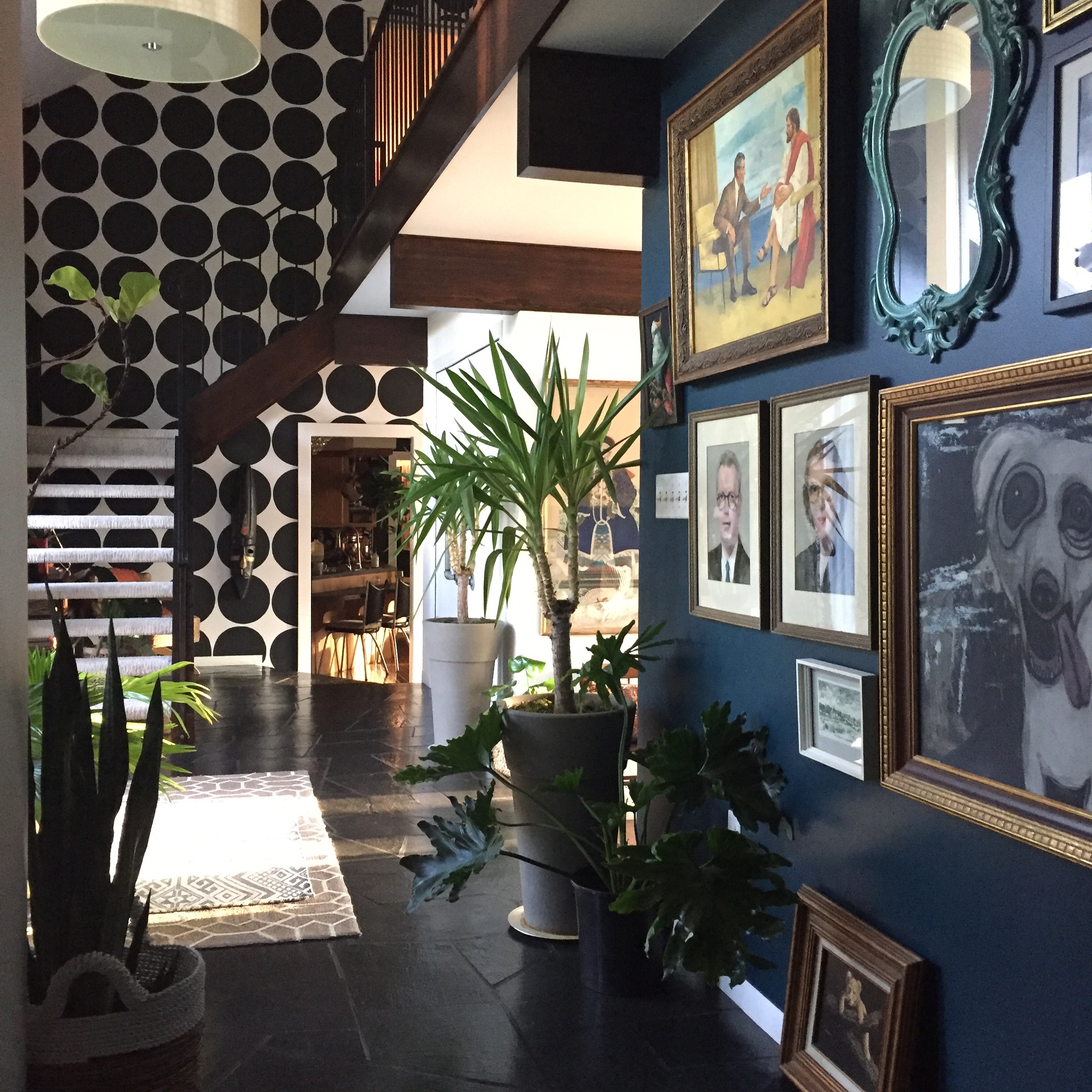 "This space is what sold us on our home. We knew walking in, this was ours." says Andrea. " Original staircase, beams and woodwork; thru our DIY renovations we tried to maintain as much of the homes originality as possible. " "The wall facing the entrance showcases one of my ever-changing gallery walls. As a painter, my love for collecting original art is never ending. I love how this curated wall is the first thing guests see."