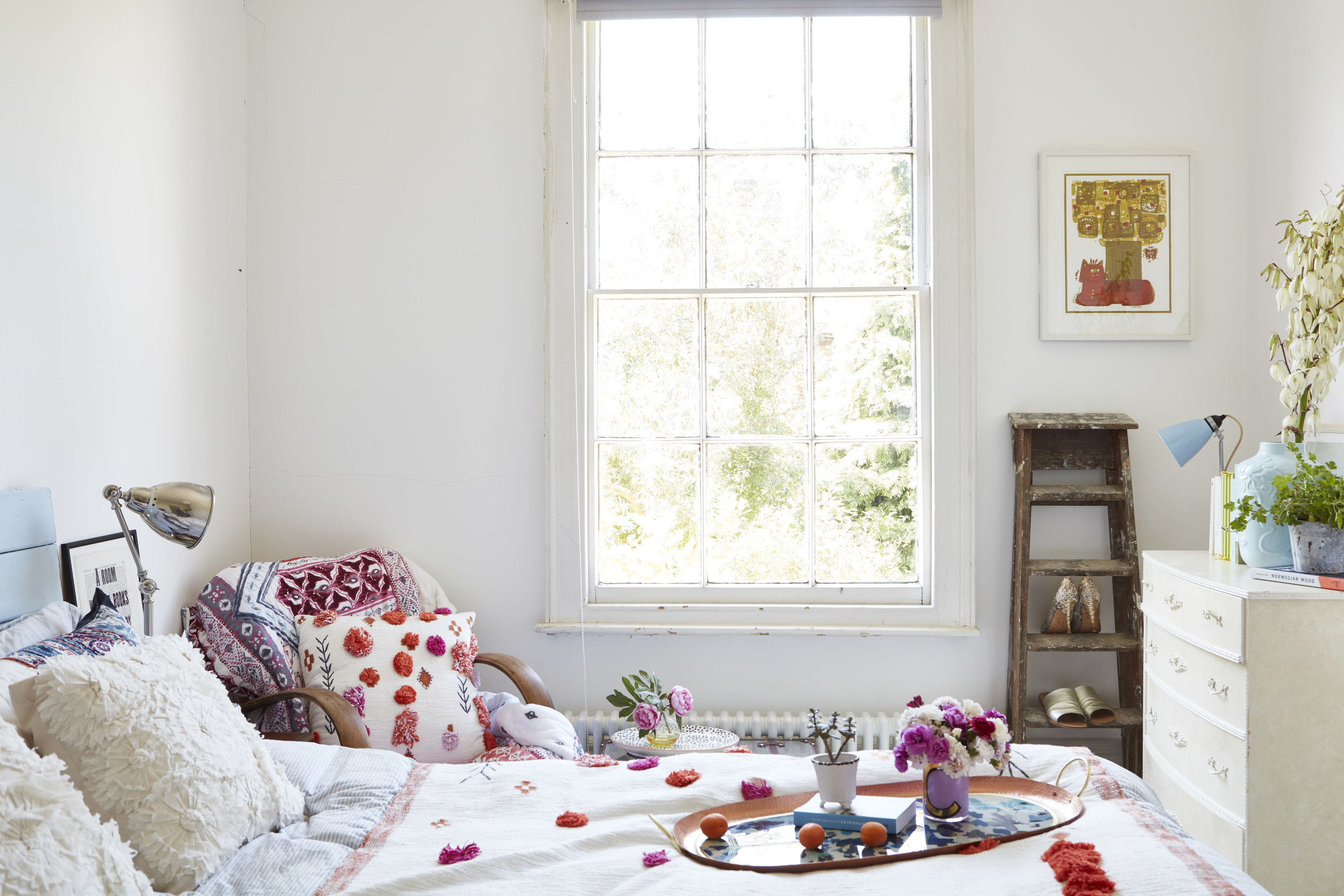 Linen, all Neptune. Lamp, Ikea. Cup, Anthropologie . Headboard painted in Bluebell by Bert and May. Quilt, cushions and throws, all Anthropologie. Walls are painted in Strong White by Farrow and Ball.
