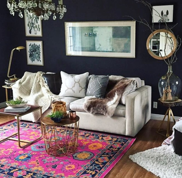 A stunning rug against dark blue walls.