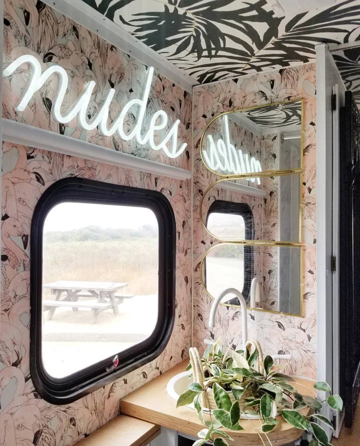 The bathroom. Flamingo Wallpaper from @newwall. "nudes" sign from @britelitetribe. The mirror I found at the thrift store and the sink was also painted with the tub resurfacing kit. We found the faucet online, it’s made for RV’s and it’s plastic.