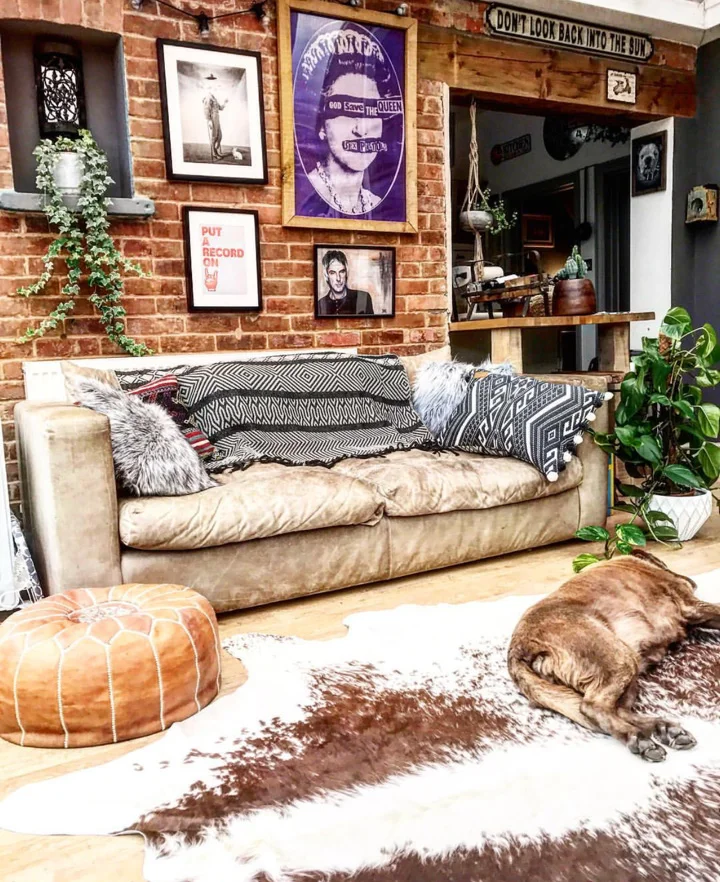 The Conservatory with exposed brick and a comfy sofa, cowhide rug and plants and art, all make for a great place to hang out in.