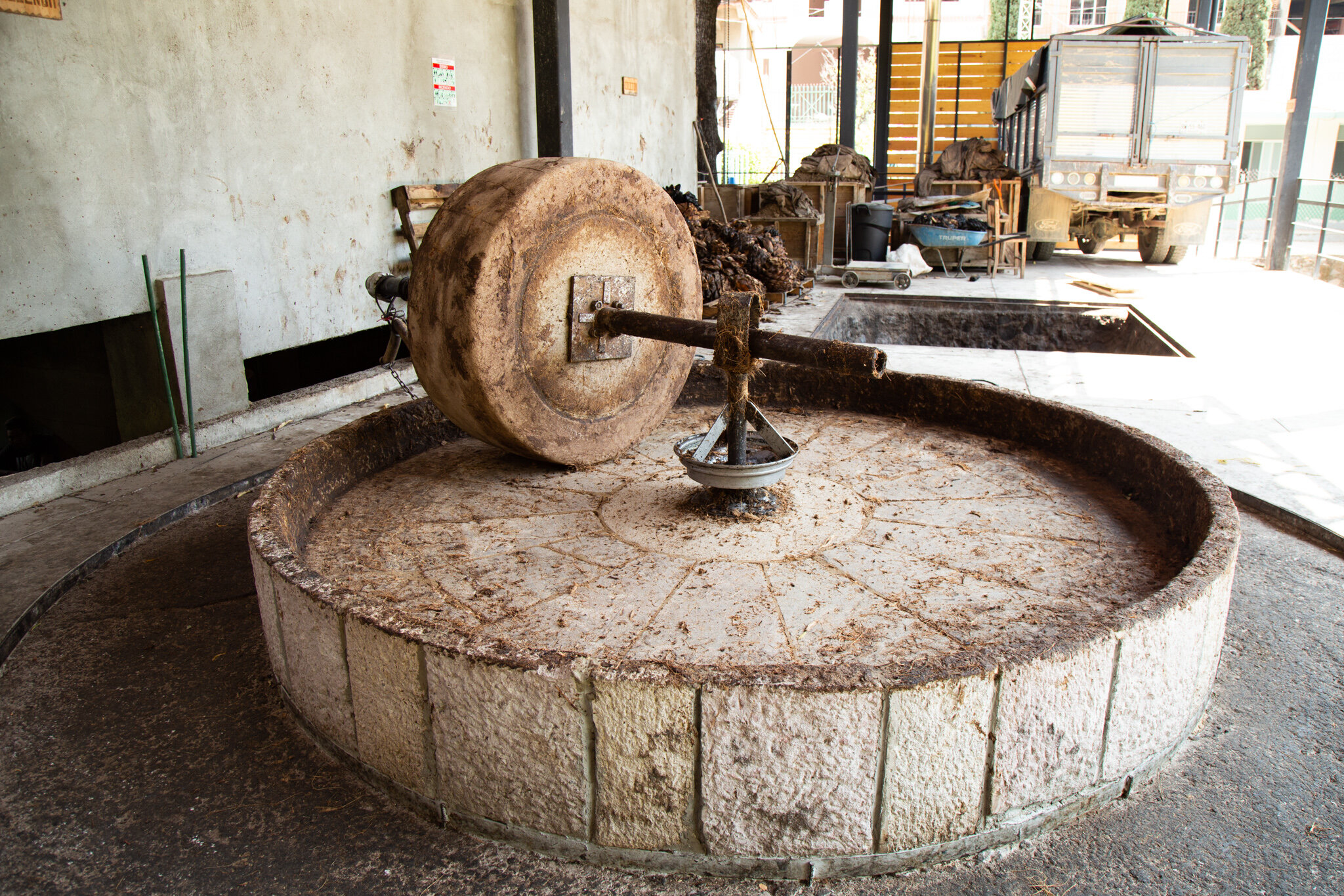 Cement wheel for crushing the agave hearts.