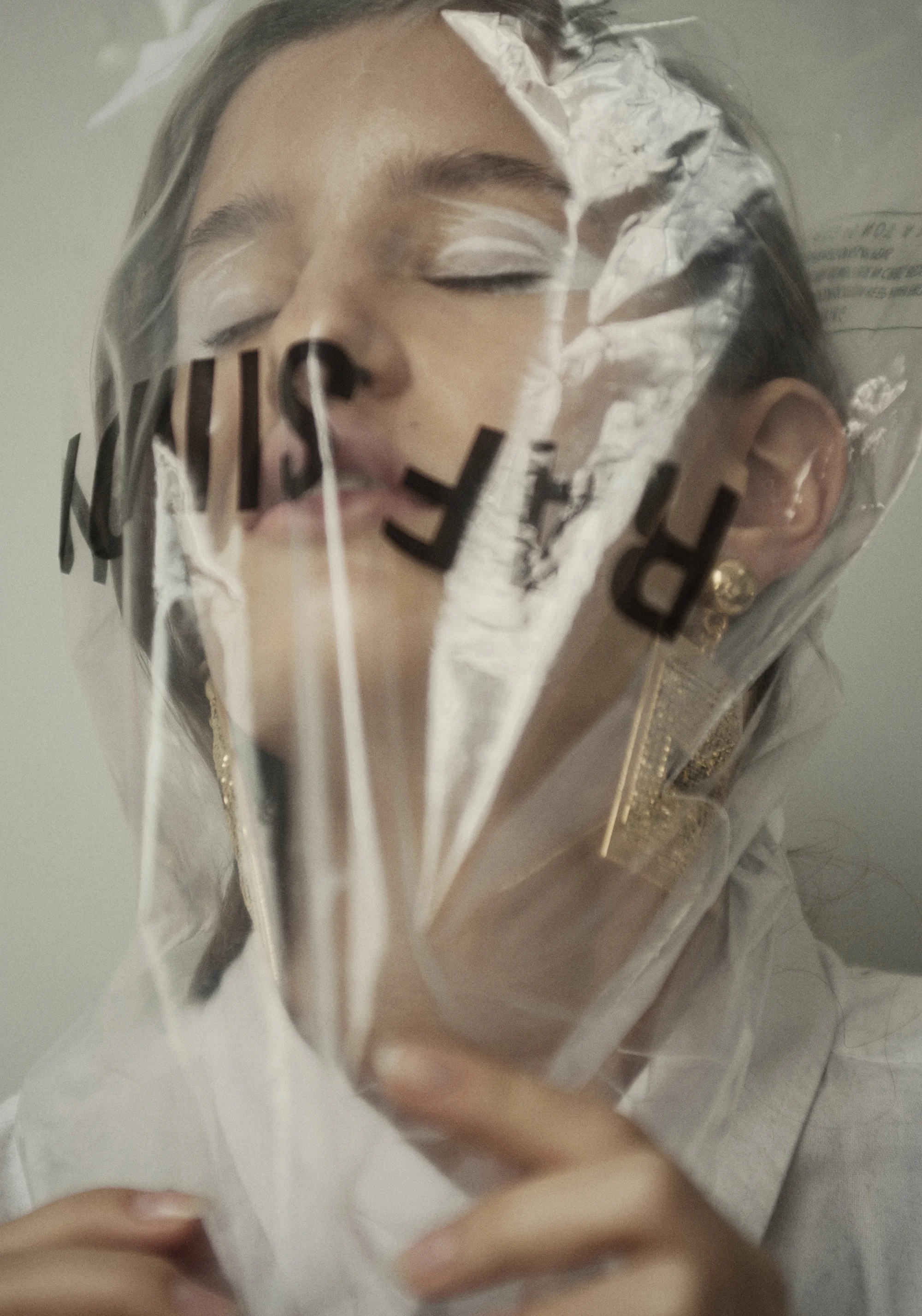 Plastic bag Raf Simons . White shirt Acne Studios . Earrings Moschino X H&M