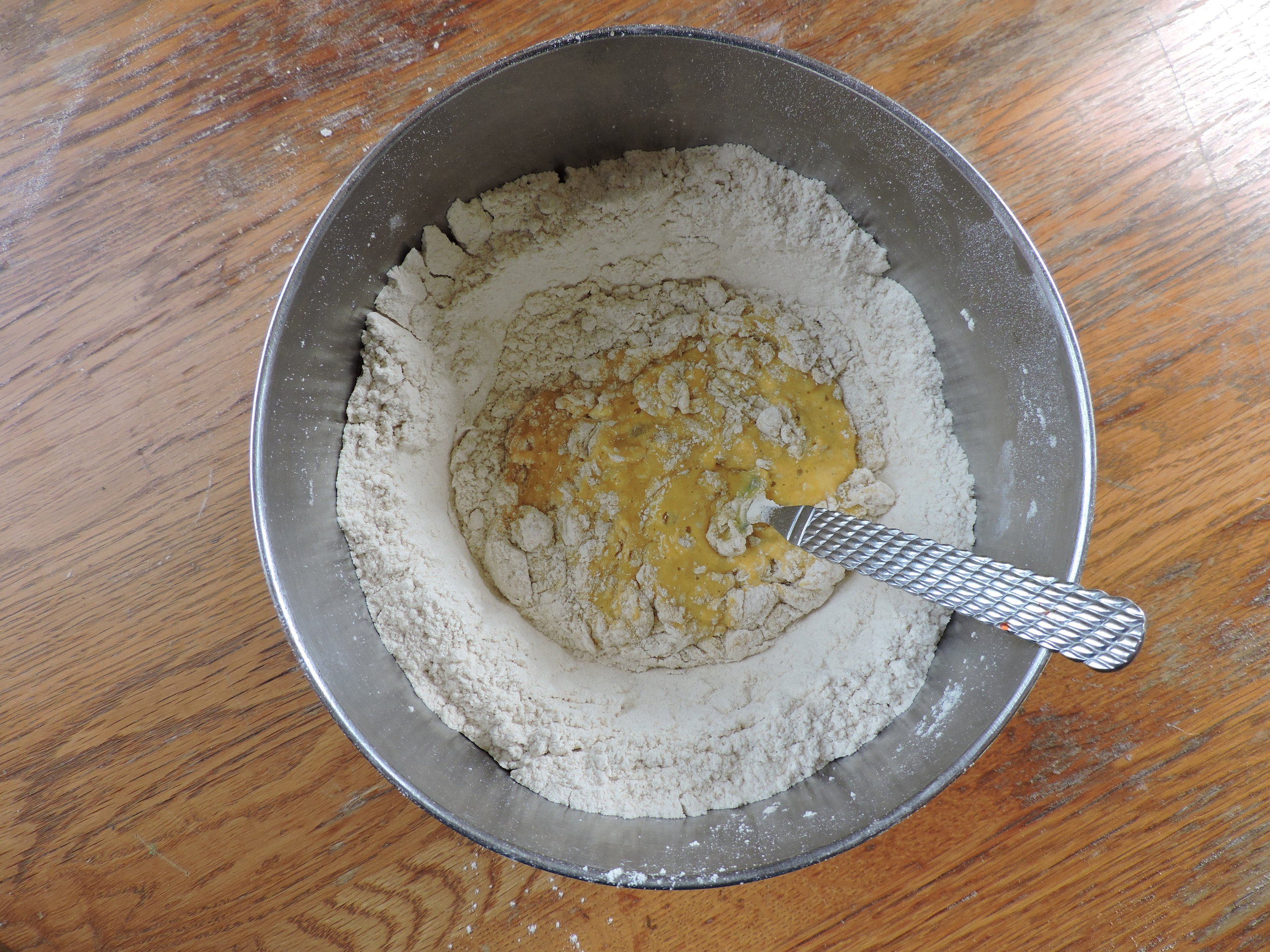  Slowly incorporate flour into egg mixture. 