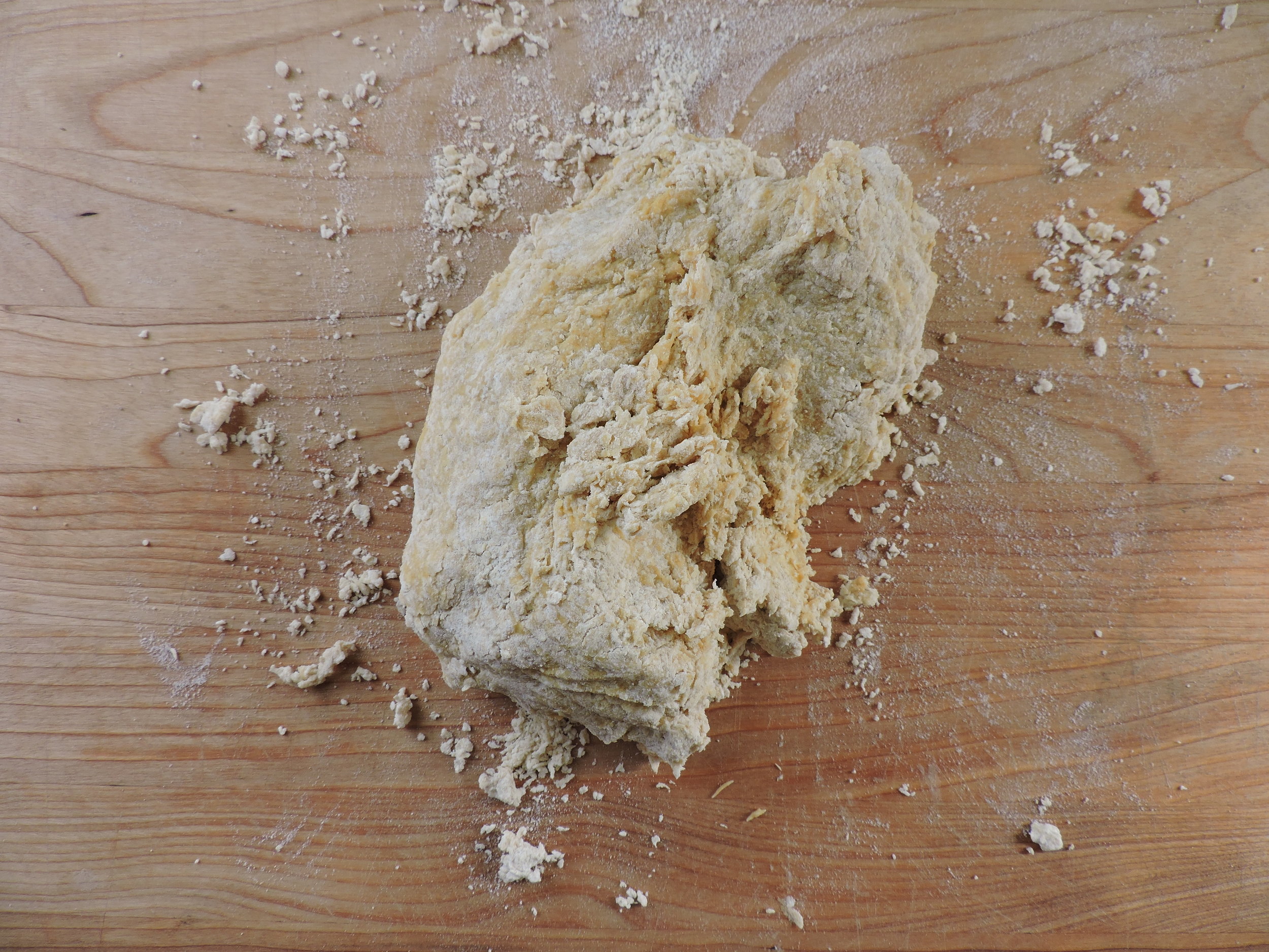  A few quick squeezes brings the dough together. If that doesn't happen (i.e. it's too crumbly), add more water, very small bits at a time. 