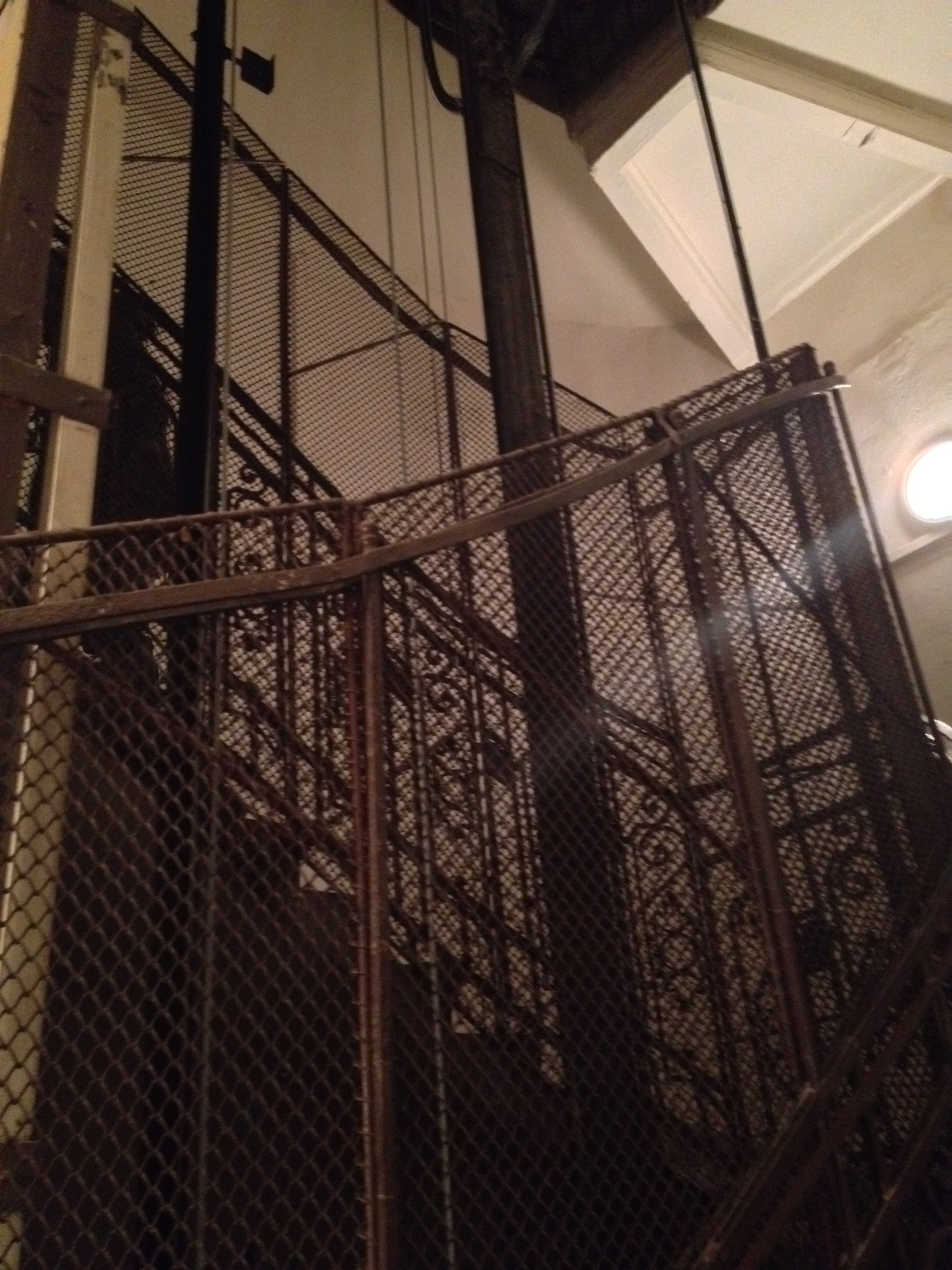 We walk up three flights of stairs surrounding this elevator cage. The lights in this building (and most others) are on a timer. The girls freak whenever the lights go out before we get to the door of our school on the third floor--I don't particularly like it either! 