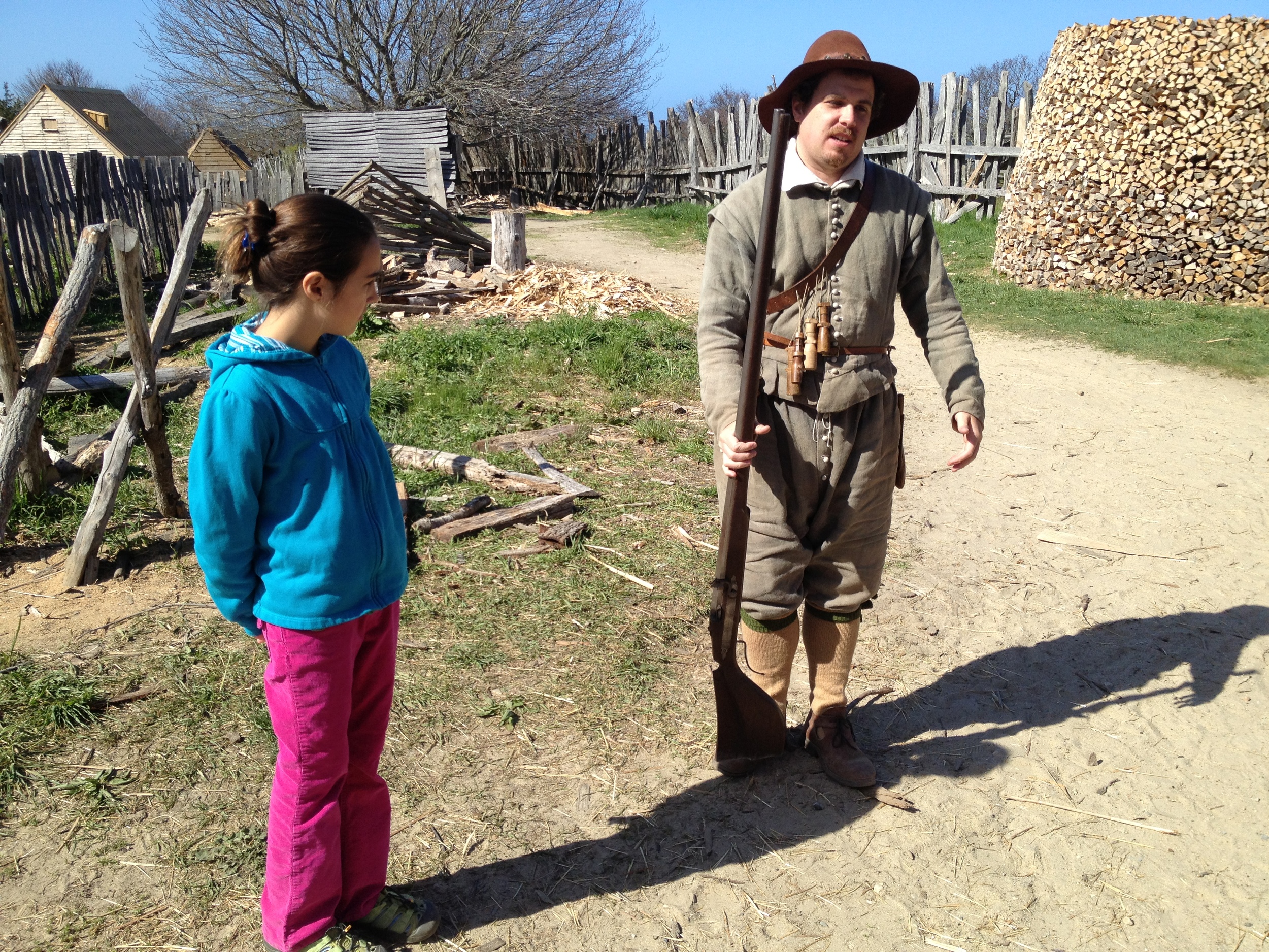 The girls learning from a Plimouth character who reenacted an actual person who sailed on the Mayflower and settled there. 