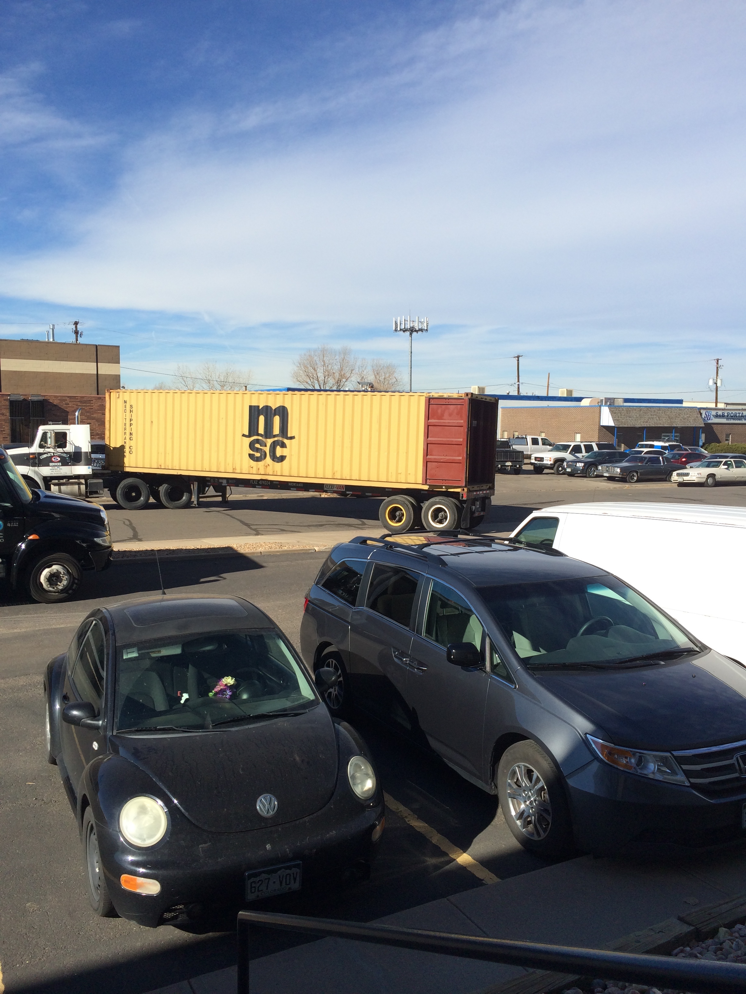 Here comes our container, into which the warehouse guys transferred all of our stuff, built a wall, and then drove our swagger wagon in it (the van pictured in front was a gift and cars in Europe are super expensive, so we're taking it with us!).