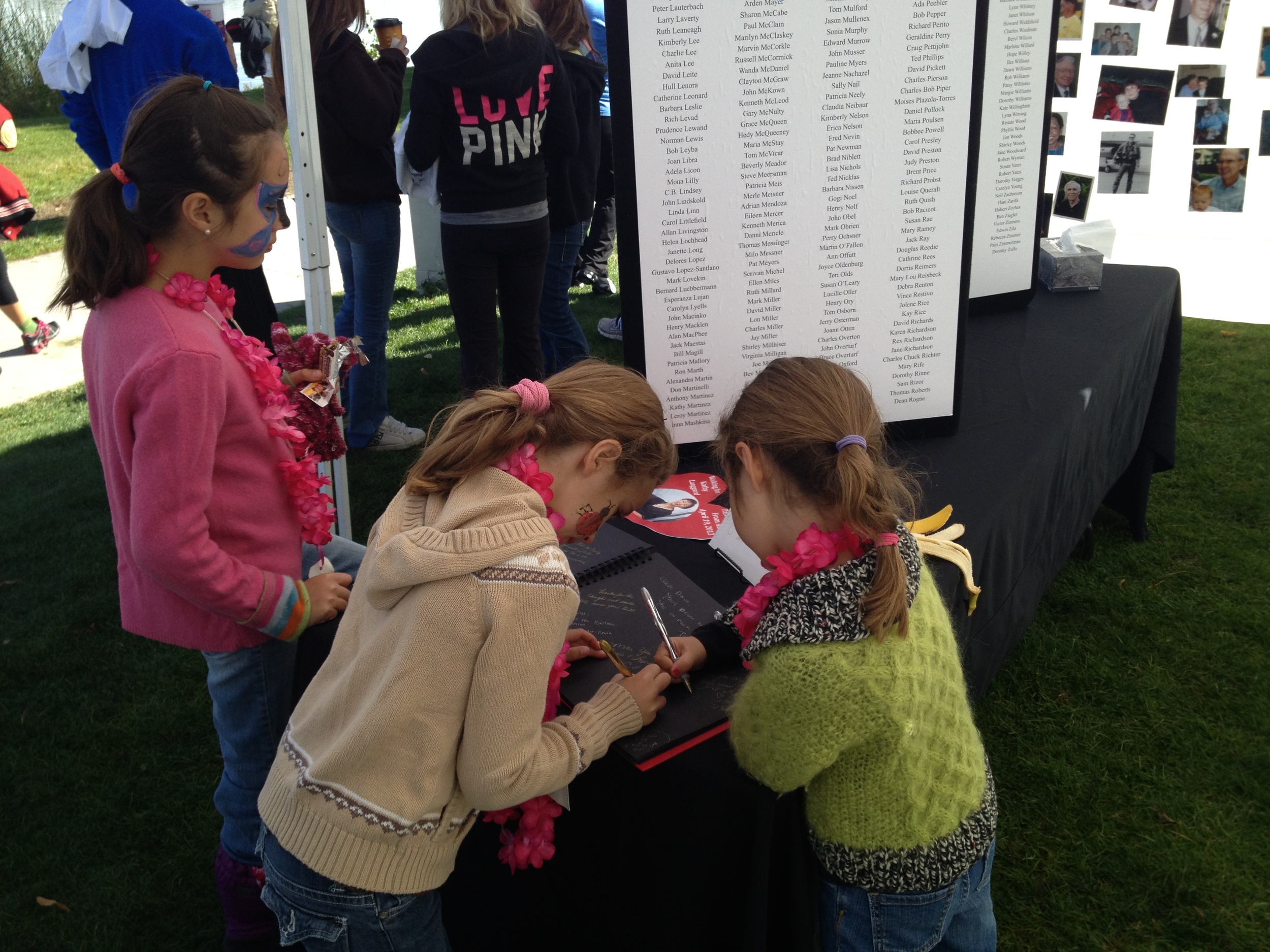 The girls signing the memory book. Their messages said, "I miss you, Grammie. I love you." 