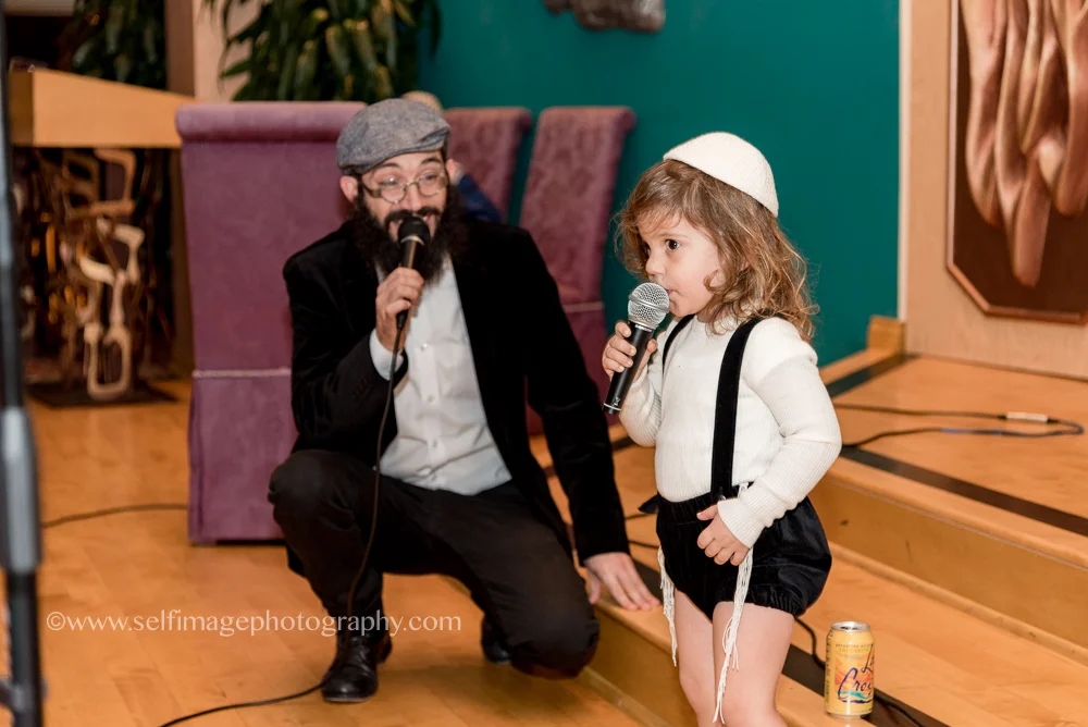 three-year-old-boy-singing-at-brithday-party