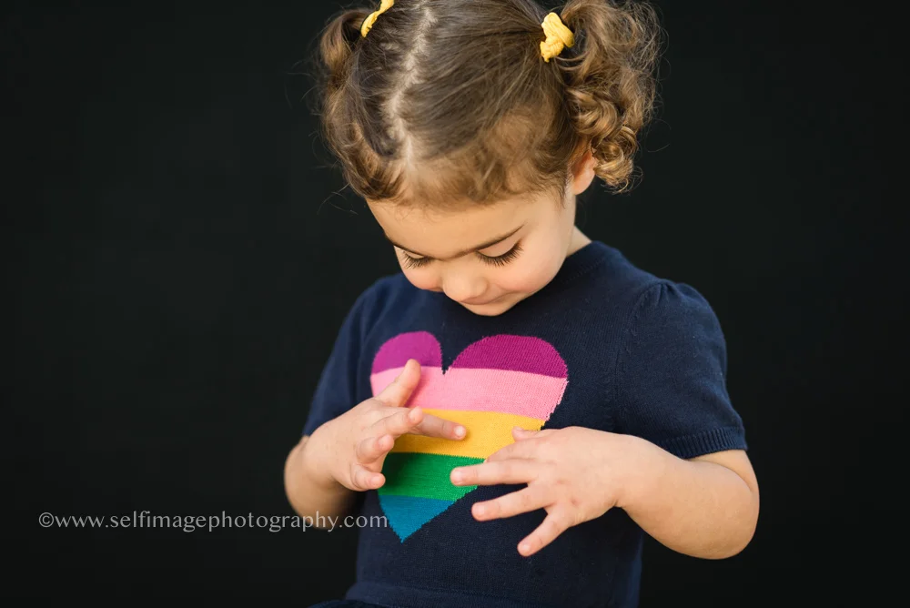 little girl looking at her dress