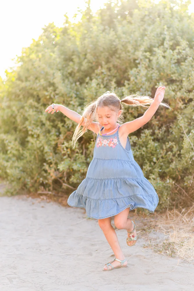 6 year old girl dancing at the beach