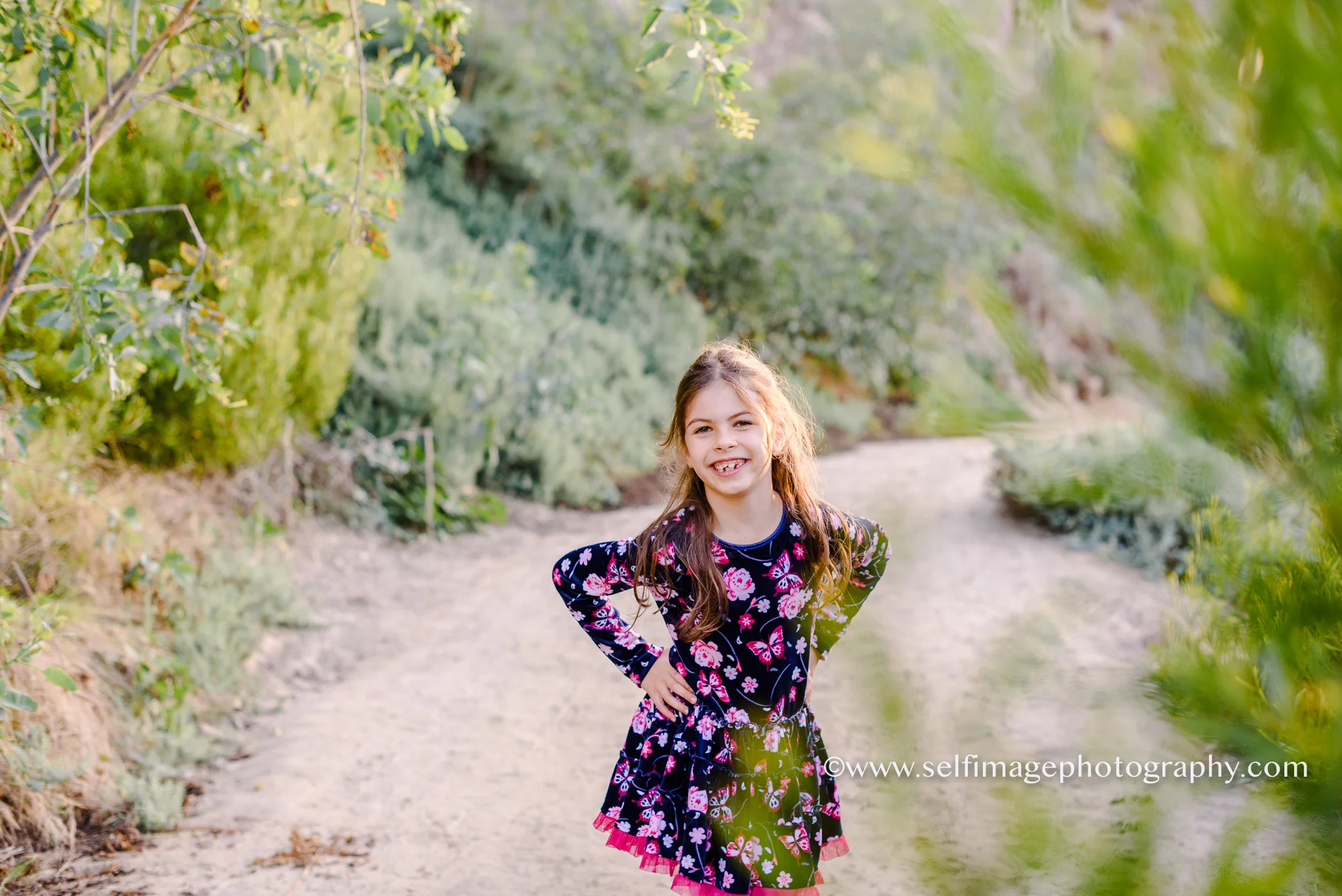 girl standing behind the trees