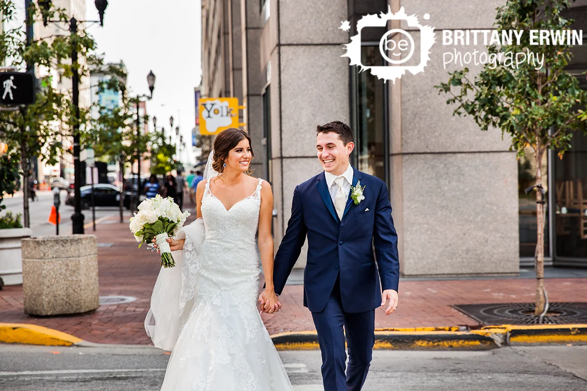 Indianapolis-wedding-photographer-urban-couple-walk-cross-street-fun-bridal-portrait.jpg