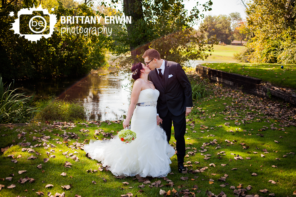 Indianapolis-wedding-photographer-couple-kiss-near-pond-Hillcrest-Country-Club.jpg