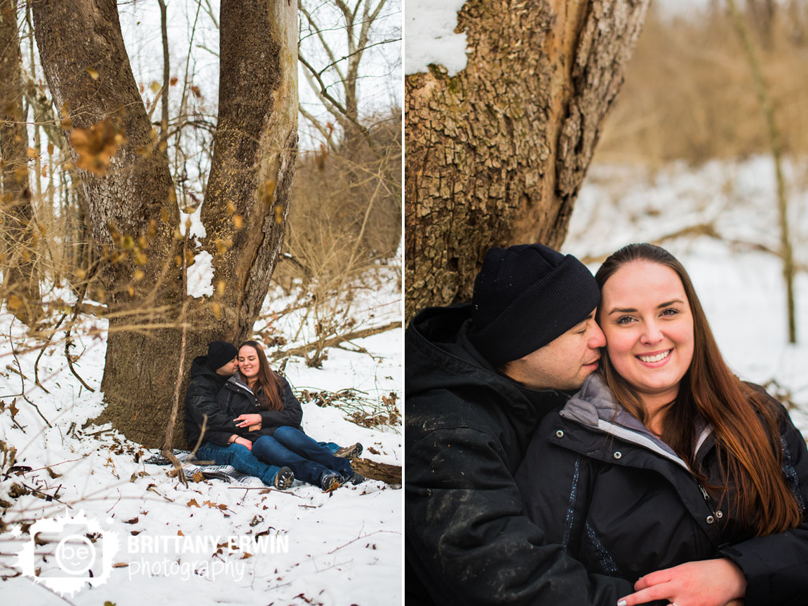 Indianapolis-winter-engagement-photographer-couple-snuggle-under-tree-in-snow.jpg