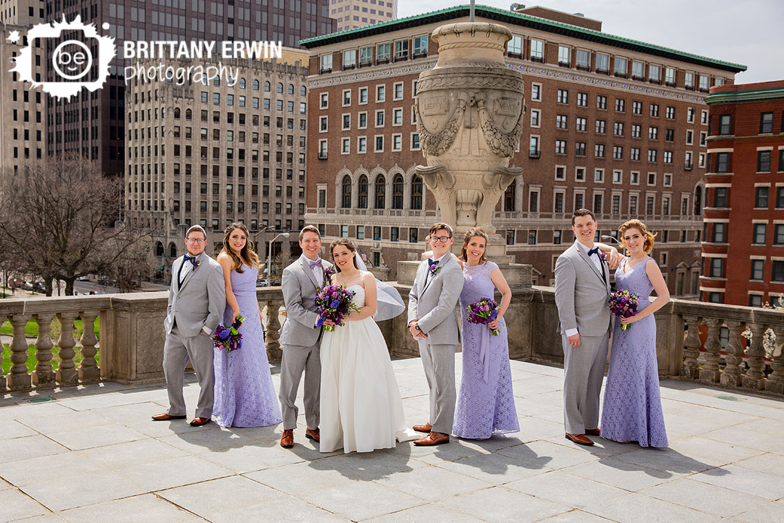 Downtown-Indianapolis-skyline-Indiana-war-memorial-bridal-party-group-creative-pose-violets-are-blue-bouquets.jpg