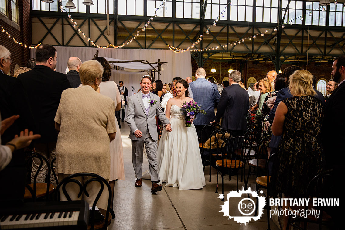 Downtown-Indianapolis-wedding-ceremony-photography-couple-walk-down-aisle-clapping.jpg