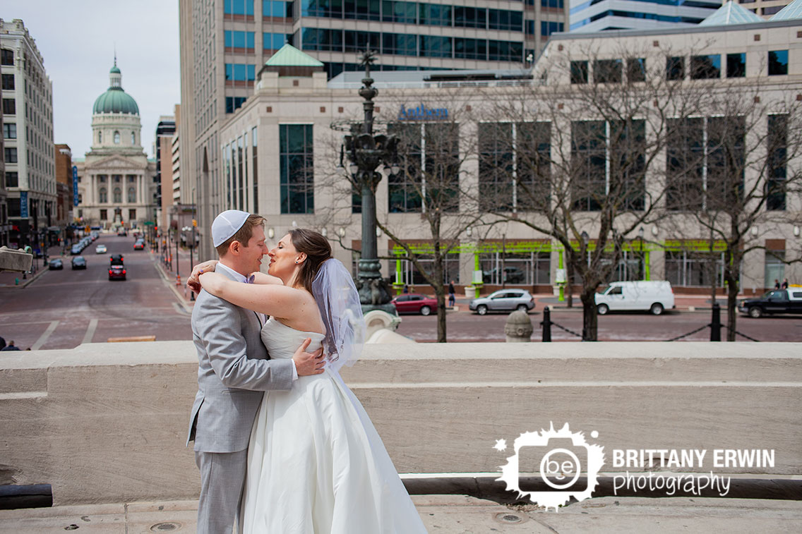 Downtown-Indianapolis-wedding-photographer-first-look-on-monument-circle-skyline-background.jpg