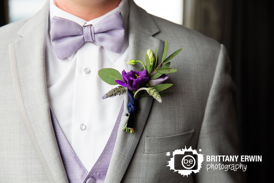 Downtown-Indianapolis-wedding-photographer-violets-are-blue-boutonniere-on-groom-purple-flower-grey-suit.jpg