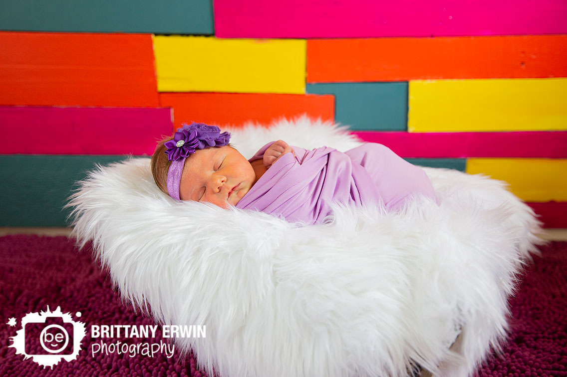 Indianapolis-newborn-baby-girl-portrait-photographer-pallet-wall-purple-wrap-matching-headband.jpg