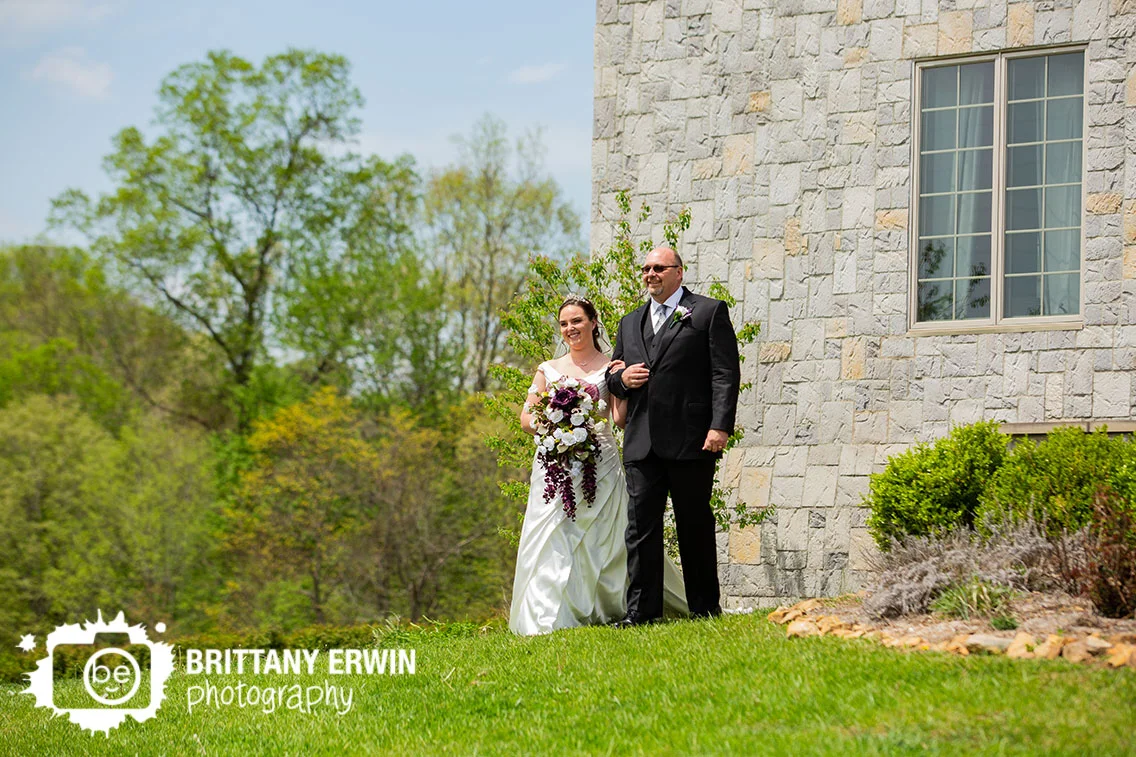 Clayshire-Castle-wedding-ceremony-photographer-bride-walking-from-building-with-father.jpg