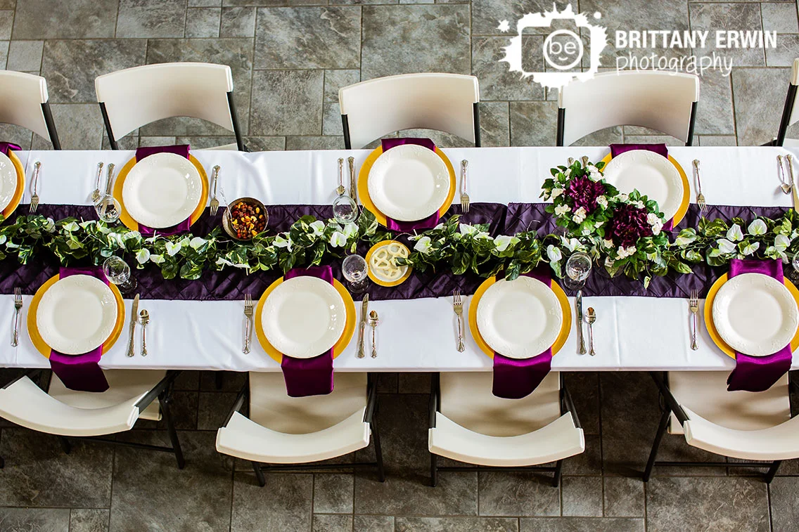 Clayshire-Castle-wedding-photographer-long-banquet-table-purple-runner-charger-napkin-place-setting.jpg