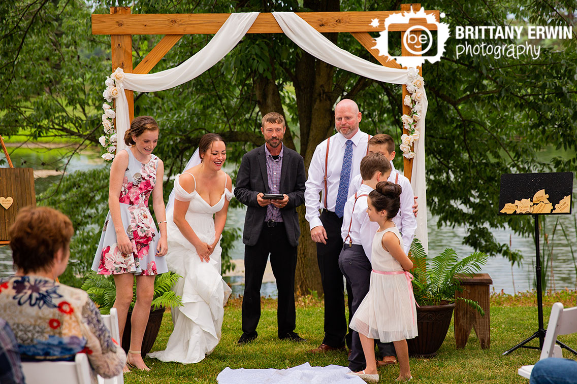 Bride-laughing-outdoor-wedding-ceremony-daughter-at-altar.jpg