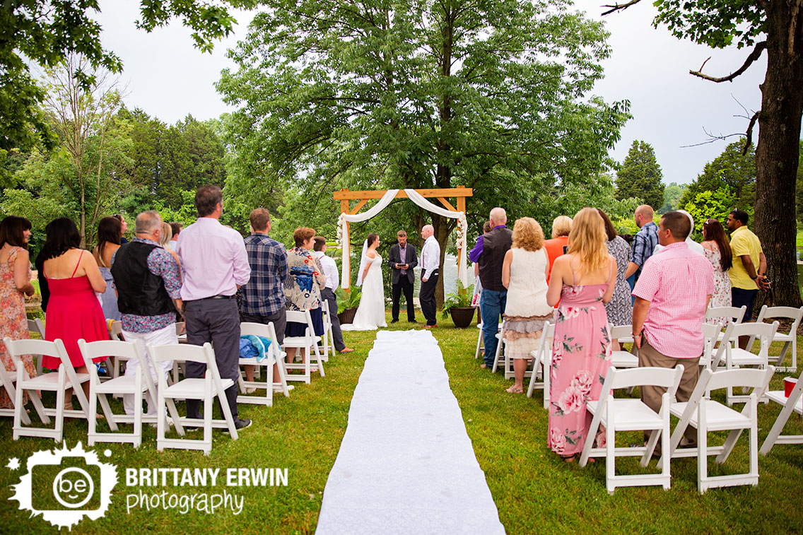 Ceremony-wedding-photographer-couple-at-altar-wooden-arbor-aisle-runner.jpg
