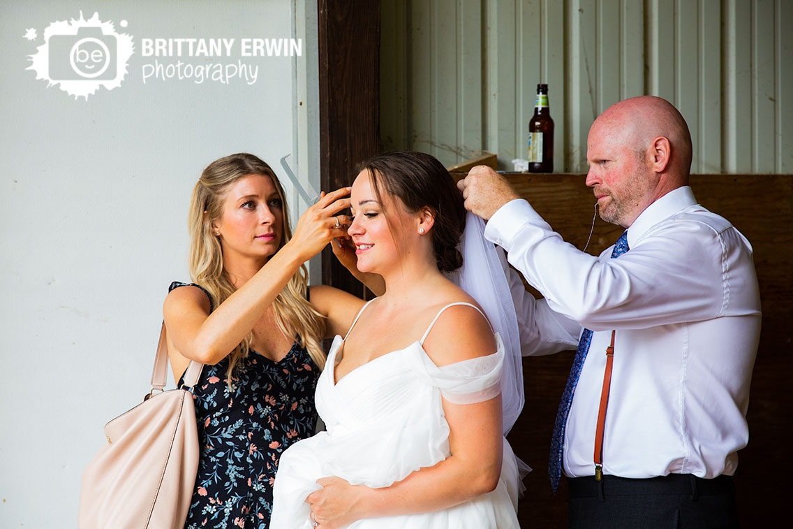 Indianapolis-wedding-photographer-bride-pampered-hair-groom-sewing-veil.jpg