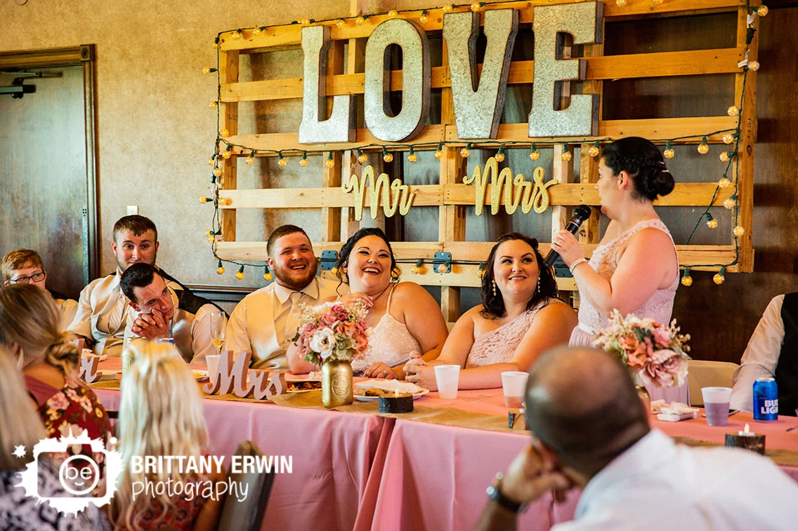 mr-mrs-sign-wedding-reception-toast-bride-laughing.jpg