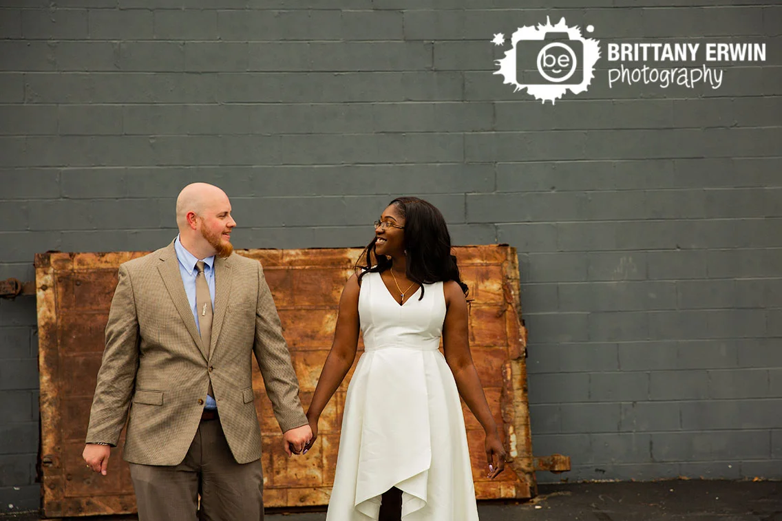 rustic-rusty-door-funky-bridal-portraits-couple-walking-outside-speakeasy.jpg