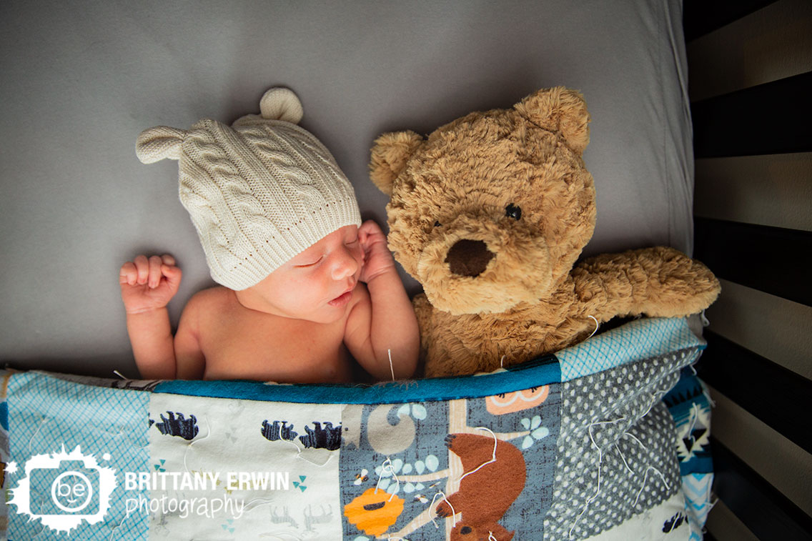 sleepy-baby-boy-in-crib-tucked-in-with-teddy-bear.jpg