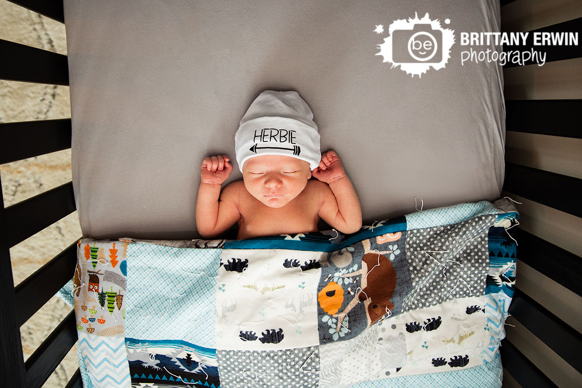 Indianapolis-newborn-lifestyle-portrait-photographer-baby-boy-asleep-tucked-in-crib-custom-hat.jpg